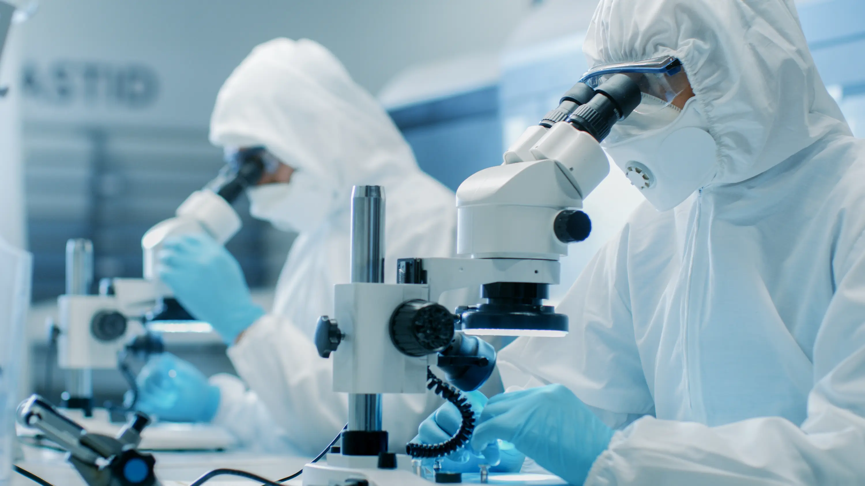 scientists looking in microscopes